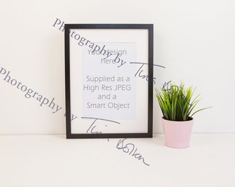Download Free Black Frame with mount, portrait mock up, green plant, pink pot. Perfect mockup for prints A3 and A4 PSD Template