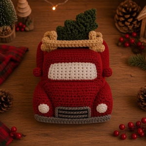 May include: A red crochet truck featuring a white windshield, a gray front bumper and grille, and two small white headlights. A tan crocheted roof rack is attached to the top, carrying a dark green crocheted Christmas tree on its roof.