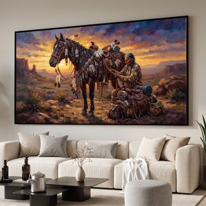 May include: A rectangular wall art print featuring an oil painting of a person in traditional attire adjusting a saddle on a dark horse. The scene is set in a desert landscape at sunset with purple and orange clouds above rocky formations.