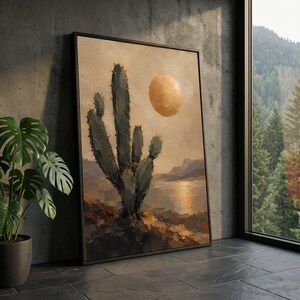 Puede incluir: Una pieza de arte mural rectangular enmarcada que presenta una pintura al óleo de un paisaje desértico. La obra muestra un cactus verde oscuro en primer plano contra un cielo beige con un sol dorado, sobre un cuerpo de agua y colinas lejanas.