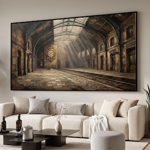 May include: A large rectangular wall art print depicting an old train station interior with arched metal ceilings, stone floors, and a prominent gold clock on the wall. Beams of light shine through the glass roof onto the platform and tracks.