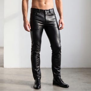 May include: Black leather trousers featuring a classic five-pocket design, a button fly closure, and belt loops. The trousers have a slim-fit silhouette with a smooth, polished finish and are paired with black leather dress shoes.