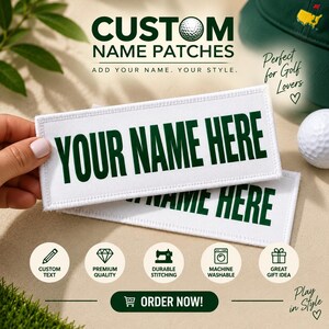 May include: Two rectangular white fabric patches with dark green embroidered text that reads YOUR NAME HERE. The patches feature a clean stitched border and are designed for customization, showcasing a golf-themed aesthetic with a golf ball.