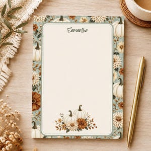 May include: A rectangular notepad with a cream-colored center and a border featuring white pumpkins, brown and cream dahlias, and green foliage. The name Samantha is printed at the top. The notepad has a light blue-green background frame.