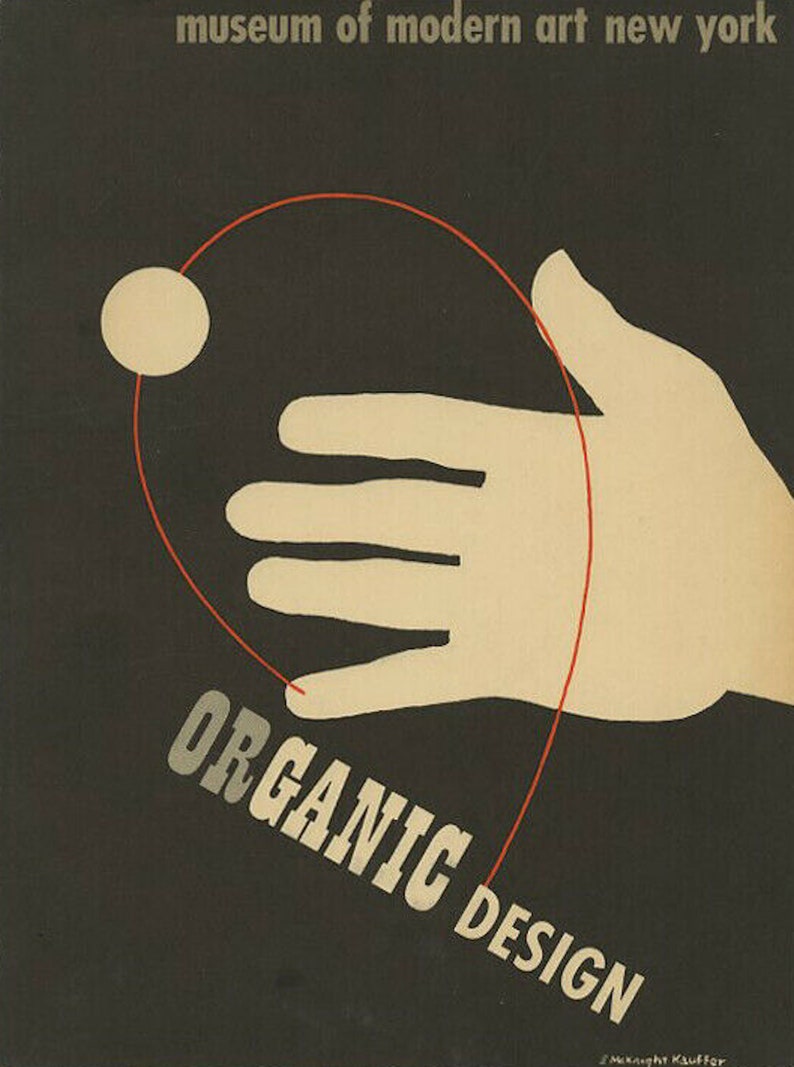 May include: A black and white poster with the text "museum of modern art new york" at the top. The poster features a white hand with a red line connecting to a white circle. The text "ORGANIC DESIGN" is written in white letters on a black background.