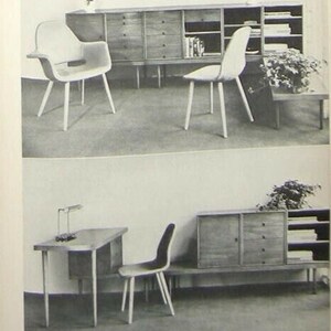 May include: Two black and white photos of mid-century modern furniture. The first photo shows a long wooden cabinet with open shelves and drawers. Two white chairs are in front of the cabinet. The second photo shows a desk with a lamp and a chair. A wooden cabinet with open shelves and drawers is behind the desk.
