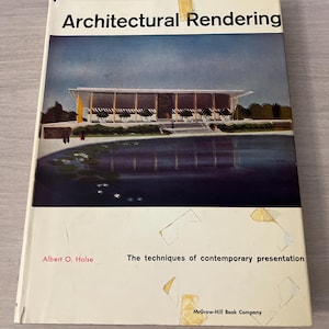 May include: A hardcover book titled Architectural Rendering by Albert O. Halse, published by McGraw-Hill Book Company. The cover features a color illustration of a modern building with a large pond in the foreground, set against a blue sky.