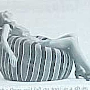 May include: Three people are sitting in different bean bag chairs. The chairs are all different colors and patterns. The first chair is black and white striped, the second chair is black and white striped, and the third chair is black and white with a floral pattern.
