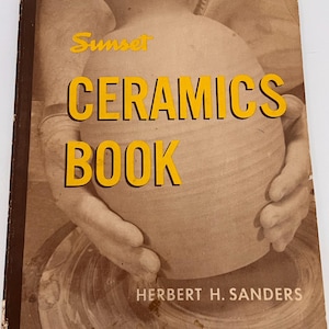 May include: A vintage "Ceramics Book" by Herbert H. Sanders. The cover shows a sepia-toned image of hands working with pottery. The title is in bold yellow letters with a black outline, and the word "Sunset" is in yellow script.