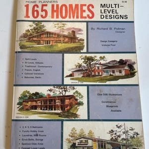 May include: Vintage book cover titled "165 Homes Multi-Level Designs." The cover features illustrations of houses and text including "Split-Levels," "3, 4, 5, 6 Bedrooms," and "Over 500 Illustrations." The designer is Richard B. Pollman.