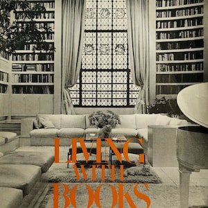 May include: A black and white photo of a living room with a large window, a couch, and a piano. The room is filled with bookshelves. The text "LIVING WITH BOOKS" is printed in orange on a rug in the center of the room. The text "RITA REIF/THE NEW YORK TIMES" is printed below the title. The price "$4.95" is printed in the bottom right corner.