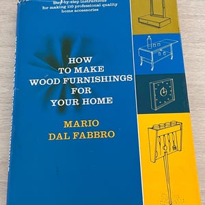 May include: A blue book titled "How to Make Wood Furnishings for Your Home" by Mario Dal Fabbro. The cover features illustrations of furniture and text that reads "Step-by-step instructions for making 110 professional quality home accessories."
