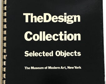 May include: Black book with white text that reads "The Design Collection Selected Objects The Museum of Modern Art, New York"