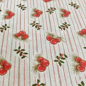 May include: Fabric featuring a repeating pattern of red berries, green holly leaves, and pine needles. The design is set against a cream background with vertical red and green stripes. The fabric has a vintage or retro aesthetic.