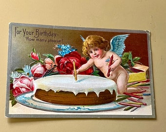 Antique embossed birthday post card with angel and cake