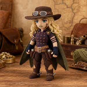 May include: A crocheted doll featuring long blonde hair, wearing a brown hat with goggles, a dark purple studded top, a brown belt with holsters, dark brown pants, and boots with silver spurs, complemented by a dark green cape draped over the shoulders.