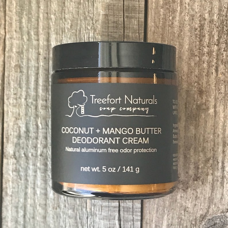 May include: A glass jar of Treefort Naturals Coconut + Mango Butter Deodorant Cream. The jar is labeled with the company name and product description. The jar is 5 ounces or 141 grams.