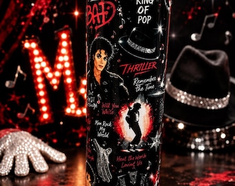 May include: A cylindrical tumbler featuring a black background with red accents and white text. The design includes a portrait of Michael Jackson, a fedora, a sequined glove, and song titles like Thriller, Bad, and Man in the Mirror. Musical notes and star motifs are scattered across the surface.