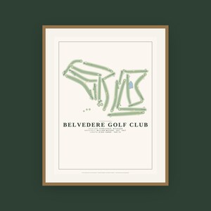 May include: A framed print of the Belvedere Golf Club course layout in Charlevoix, Michigan. The design features green fairways on a cream background with black text detailing the architect William Watson, 1927 establishment, and 6,943 yards.