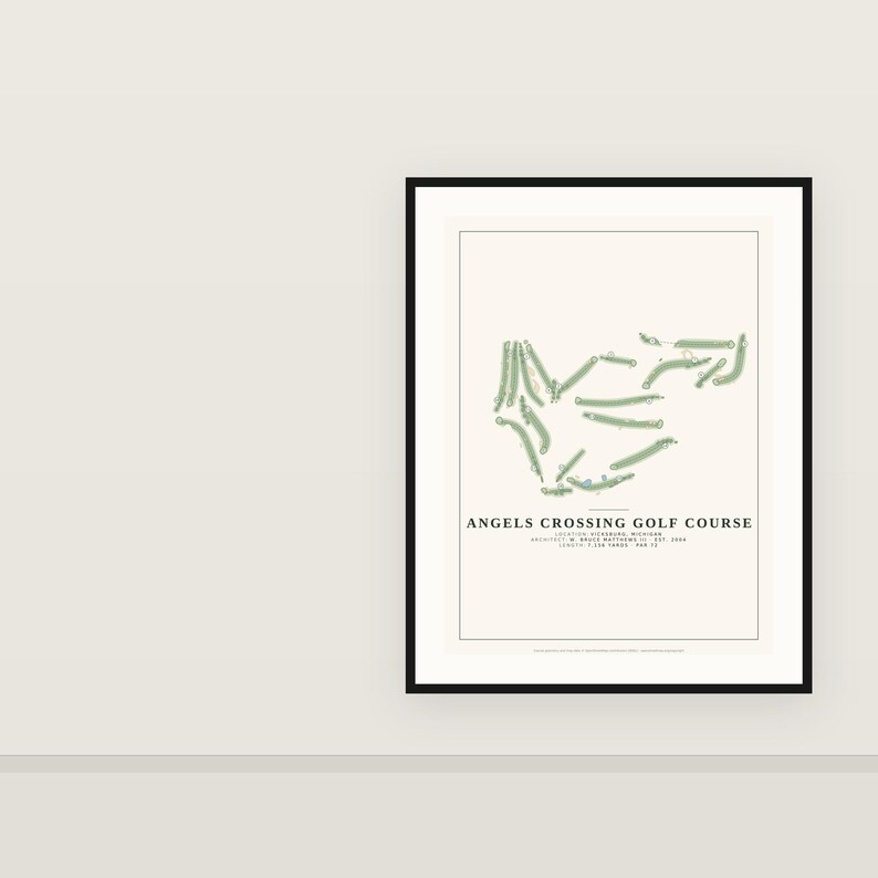 May include: A framed print featuring a minimalist map of the Angels Crossing Golf Course in Vicksburg, Michigan. The design displays green fairways on a cream background with black text detailing the location, architect, year, and length.