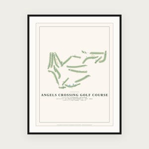 May include: A framed print featuring a map of the Angels Crossing Golf Course in Vicksburg, Michigan. The design displays the course layout in green on a cream background with text detailing the architect, establishment year, and 7,156 yards length.