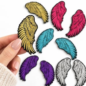 May include: A collection of embroidered wing patches in various colors including gold, hot pink, turquoise, purple, and white. Each patch features detailed stitching to represent feathers with a black border outline around the wing shape.