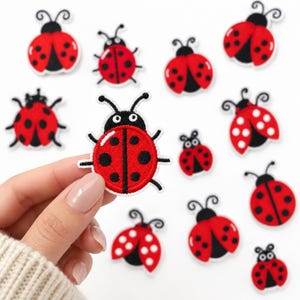 May include: A collection of embroidered ladybug patches featuring a vibrant red body with black spots, a black head, and white antennae. Each patch is circular in shape with a distinct border, showcasing a detailed insect design for textile application.