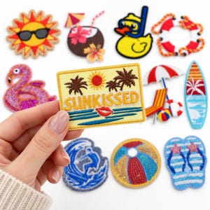 May include: A rectangular embroidered patch with a yellow background featuring a red sun, brown palm trees, blue ocean waves, a red lip icon, and the text SUNKISSED in yellow. It is surrounded by various summer-themed patches including a flamingo, surfboard, and beach ball.