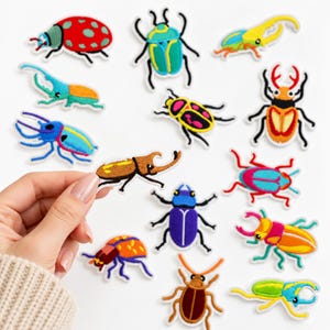 May include: A collection of colorful embroidered beetle and insect patches featuring various species in vibrant shades of red, blue, yellow, green, and purple. Each patch has a white border and detailed stitching depicting different bug shapes.