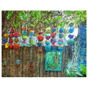 May include: A wooden fence with a blue door and a mirror. The fence is decorated with colorful round objects, some in stacks, others hanging. The objects are painted in various shades of red, blue, green, and yellow.