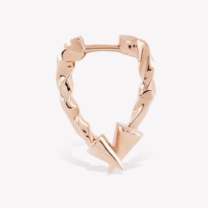 May include: A rose gold hoop earring featuring a twisted metal texture that forms a teardrop shape. The bottom of the hoop is accented with two small, pointed cone-shaped charms that meet at the center, creating a distinct and structured design.