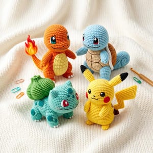 May include: Four crocheted figures representing fictional creatures: an orange lizard with a flame tail, a light blue turtle with a brown shell, a teal creature with a green bulb on its back, and a yellow creature with long ears and a lightning bolt tail.