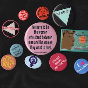 Feminist protest buttons from 80s and 90s