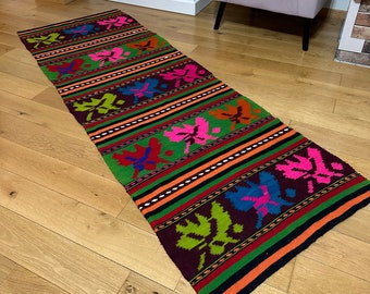 Old Romanian handwoven runner with multicolored stripes and leaves, made in the year 1970.