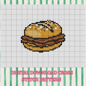May include: A digital cross stitch pattern featuring a pixel art hamburger with a golden brown bun and a dark brown patty, displayed on a white grid background with the text DIGITAL DOWNLOAD CROSS STITCH PATTERN printed in pink.
