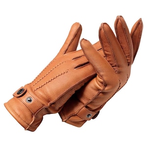 May include: A pair of tan leather gloves featuring a textured surface, three rows of decorative stitching on the back of the hand, and a wrist strap secured with two metallic snap buttons. The gloves are positioned overlapping each other.