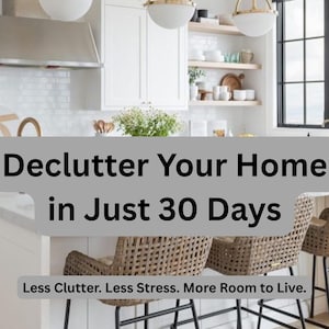 May include: A kitchen interior featuring two woven bar stools with black metal legs, white cabinetry, and three brass pendant lights. The text reads: Declutter Your Home in Just 30 Days. Less Clutter. Less Stress. More Room to Live. AndreaMadeTreasures.
