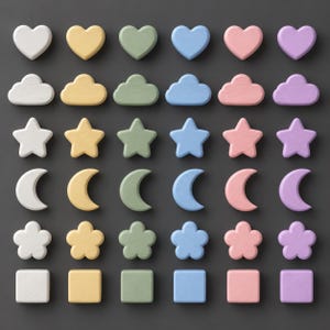 May include: A collection of thirty-six wooden shapes arranged in a grid, featuring six rows and six columns. The shapes include hearts, clouds, stars, moons, flowers, and squares, each presented in white, yellow, green, blue, pink, and purple colours.