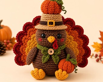 May include: A crocheted turkey figurine featuring a brown body, a fan-shaped tail in shades of red, orange, and yellow, and a tan pilgrim hat topped with a small orange pumpkin. The turkey wears a green scarf with a wooden button and holds a pumpkin.