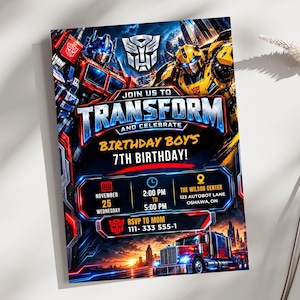 May include: A rectangular birthday invitation card featuring Optimus Prime and Bumblebee graphics. The text reads JOIN US TO TRANSFORM AND CELEBRATE BIRTHDAY BOY'S 7TH BIRTHDAY, NOVEMBER 25, 2:00 PM TO 5:00 PM, THE WILSON CENTER 123 AUTOBOT LANE OSHAWA, ON, RSVP TO MOM 111-333 555-1.