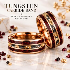 May include: Two rose gold tungsten carbide bands featuring a central inlay of crushed red, black, and gold glitter. The text TUNGSTEN CARBIDE BAND and FREE CUSTOMIZED ENGRAVING is visible above the rings, which are surrounded by small red and gold stones.