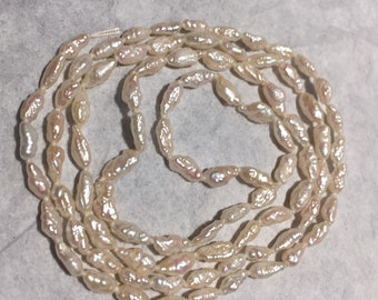 Rare Keshi Pearls. 25" knotted strand. High luster rice shape from Japan. Vintage.
