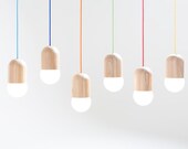 Light Bean is a lamp fixture made of Russian oak. Globe bulb is not only the source of light but also an integral part of the shape.