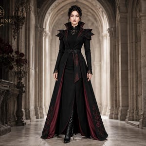 Women’s gothic vampire costume featuring a black Victorian long coat, burgundy embroidered panels, high collar and dramatic shoulders.