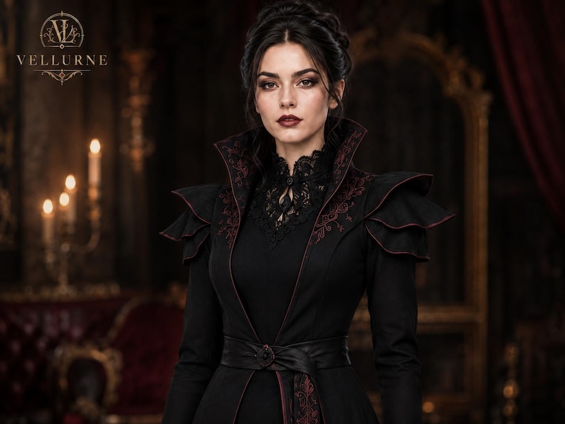 Close-up of gothic steampunk coat showing structured high collar, burgundy embroidery, layered shoulders, lace neckline and waist belt.