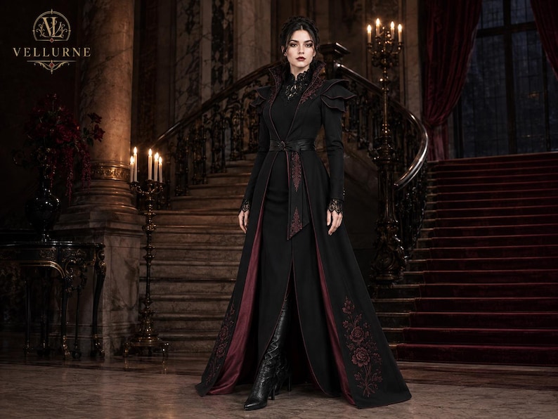 Victorian vampire coat for women in black and burgundy with embroidered floral details, dramatic shoulders and long gothic silhouette.