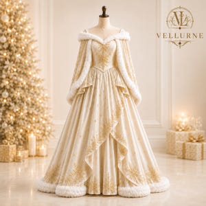 May include: A floor-length cream-colored gown featuring an off-the-shoulder neckline, long flowing sleeves, and a white faux fur trim. The dress is adorned with intricate gold snowflake embroidery throughout the bodice and skirt.