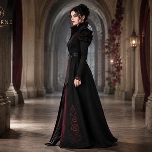 Women’s gothic vampire coat side view featuring black and burgundy Victorian styling, high collar, floral embroidery and long silhouette.