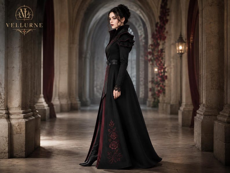Women’s gothic vampire coat side view featuring black and burgundy Victorian styling, high collar, floral embroidery and long silhouette.