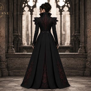Back view of women’s gothic Victorian long coat with burgundy floral embroidery, structured high collar and fitted waist design.